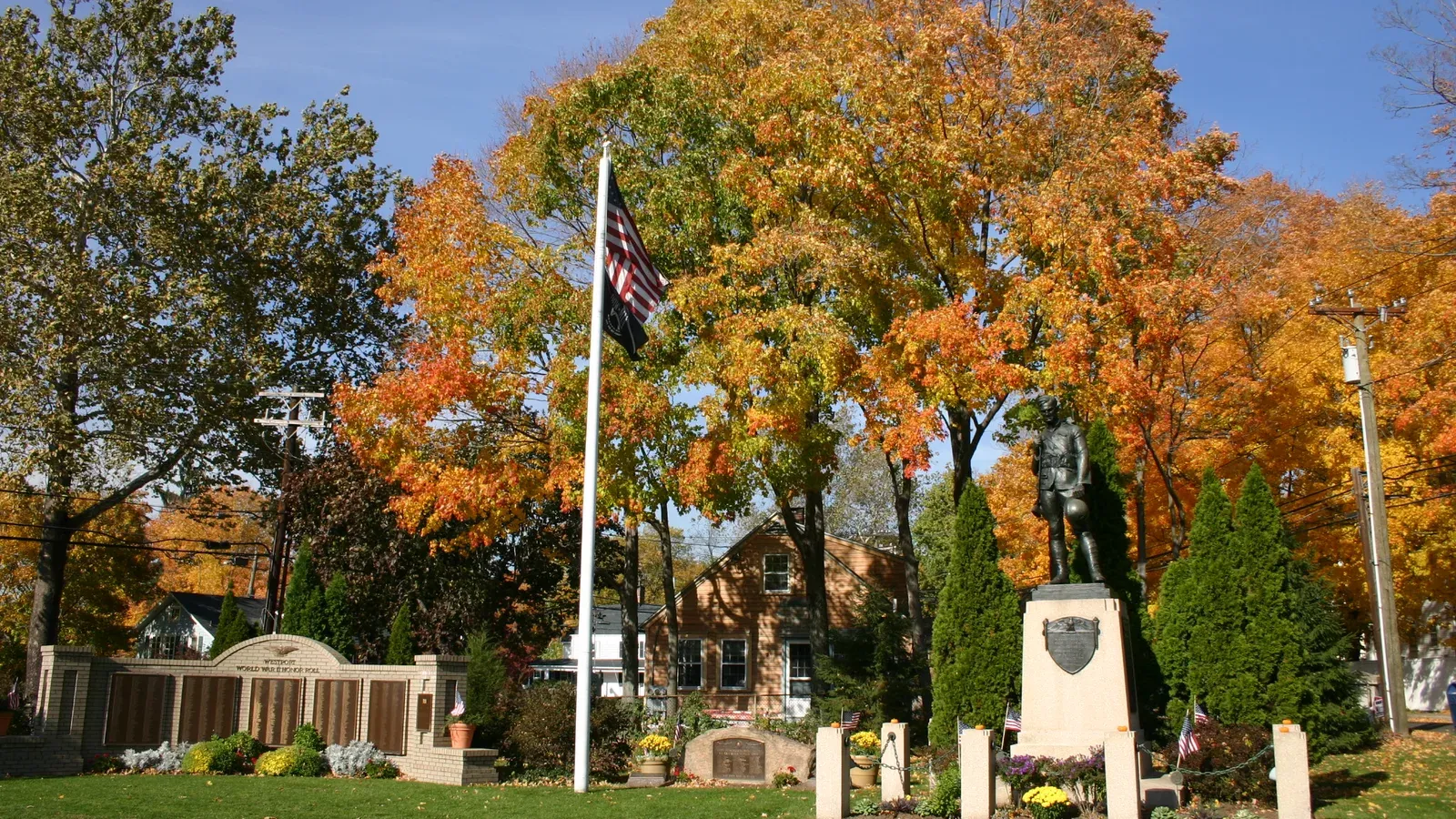 The Westport World War II memorial and doughboy statue on the town green in autumn