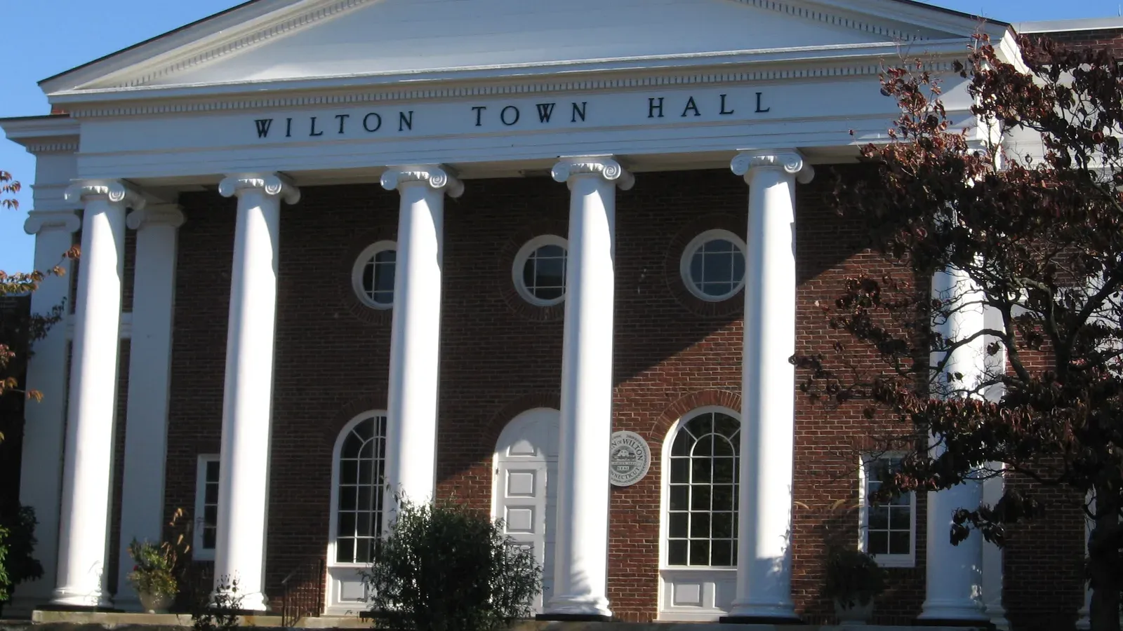 Wilton Town Hall, a brick Greek Revival building with white columns